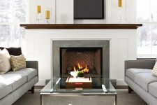 15 a modern neutral living room with a TV over the fireplace hidden with a sliding panel that is a cool and lovely solution
