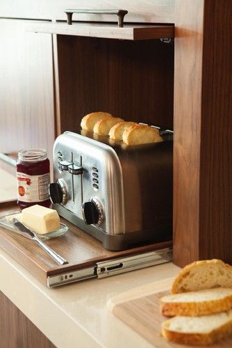 a small retractable shelf and a lifting up cabinet door for hiding the toaster - you can easily get it when needed