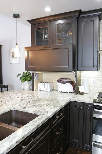 a space under a cabinet can get a comfortable raising door to hide the appliances and get a stylish look