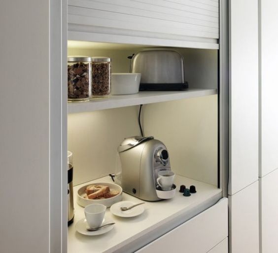 an open storage compartment finished with blinds is an ideal space for appliances and lights and sockets inside let you use them at once