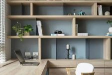22 a chic contemporary home office with a storage unit that takes a whole wall, with open and closed storage compartments, a built-in desk and chic modern chairs