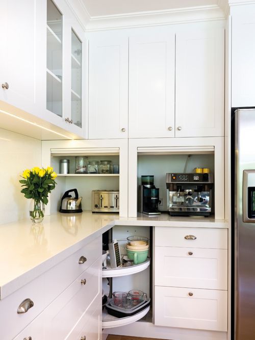 kitchen appliances hidden in comfortable countertop cabinets, with doors to raise is a stylish idea