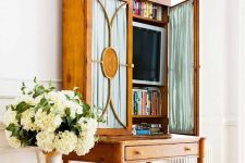 26 a refined vintage secretary style desk with a TV and books is a lovely idea to hide your TV with much elegance