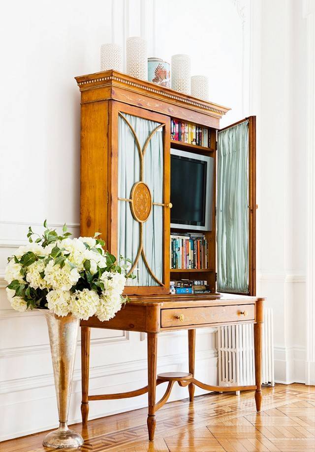 a refined vintage secretary style desk with a TV and books is a lovely idea to hide your TV with much elegance
