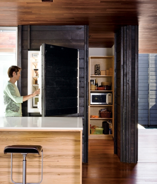 a fridge hidden inside a large cabinet doesn't spoil the look and style of your kitchen and looks absolutely integrated