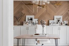 28 a beautiful home office with a rustic feel, with a herringbone clad statement wall, white shaker style cabinets, a hairpin leg desk and a cool chandelier