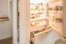 28 a fridge hidden inside kitchen cabinets and with additional side shelves for more effective storage