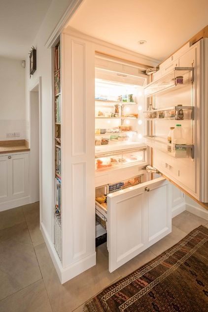 a fridge hidden inside kitchen cabinets and with additional side shelves for more effective storage