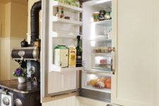 29 a fridge hidden inside kitchen cabinets to keep the look of the space sleek and elegant, without disturbing the style
