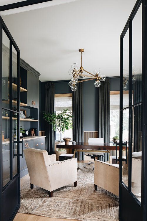 a sophisticated graphite grey home office with matching cabinets for storage an elegant stained desk and creamy chairs