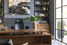 31 a refined modern home office with built-in storage units, a stained desk with two tabletops, black leather chairs