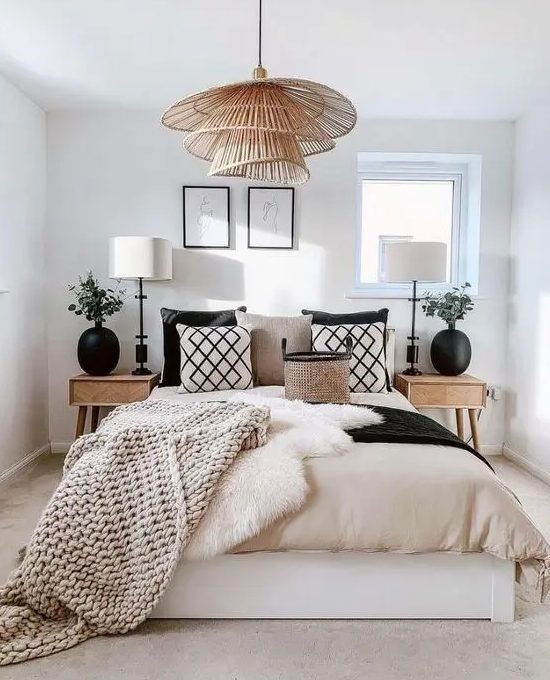 printed pillows, matching black vases and a creative tiered pendant lamp make this bedroom look unusual, stylish and bold
