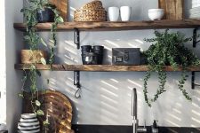 rough wood is a nice addition to a modern black and white kitchen