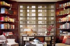 a quirky and refined space with lots of built-in bookshelves, neutral furniture, a duo of coffee tables, a coquelicot ceiling and a desk