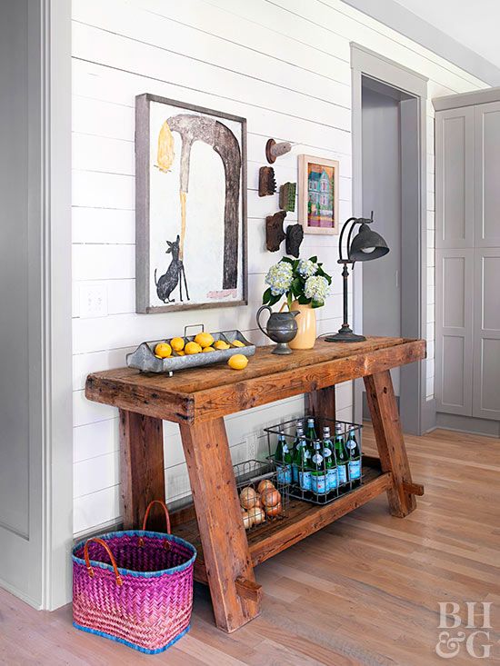 a stained rough wood console table like this one will easily add a cozy farmhouse touch to any space and will make it more welcoming