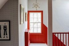 a stylish space done in neutrals, with printed wallpaper and bold coquelicot touches for a brighter and cooler look