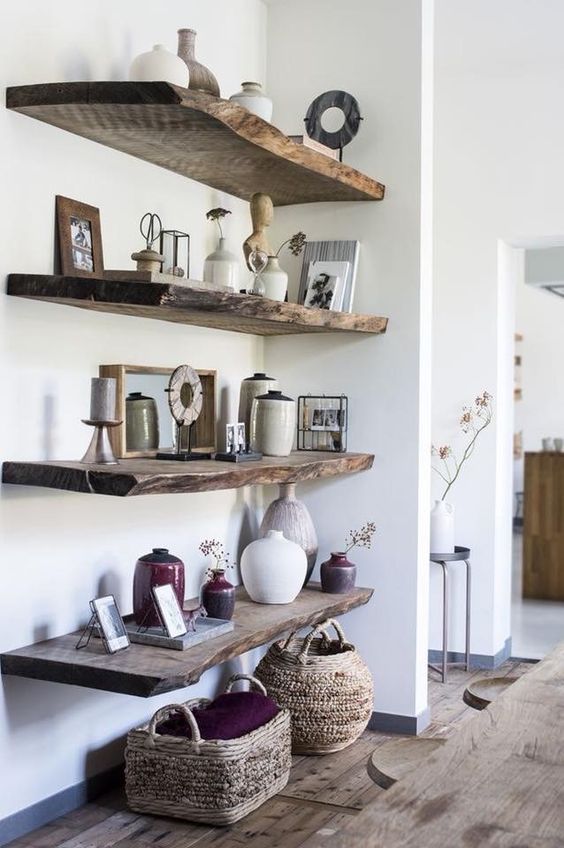 rough wood shelves in the wakward corner add a bit of rustic chic to the space, and baskets help with that, too