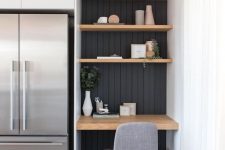 12 a small awkward nook with black shiplap, built-in shelves and a desk, a comfy grye chair for working in the kitchen