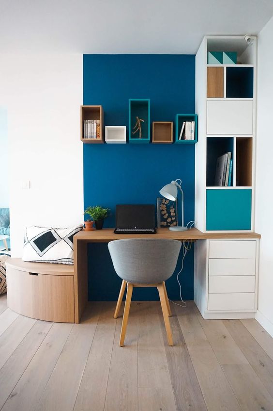 a creative curved awkward nook turned into a home office with a navy accent, built-in shelves and a desk plus a small bench with a drawer