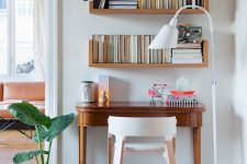 33 a small and stylish nook made a home office with three bookshelves and a vintage desk, a plywood stool and a cool floor lamp