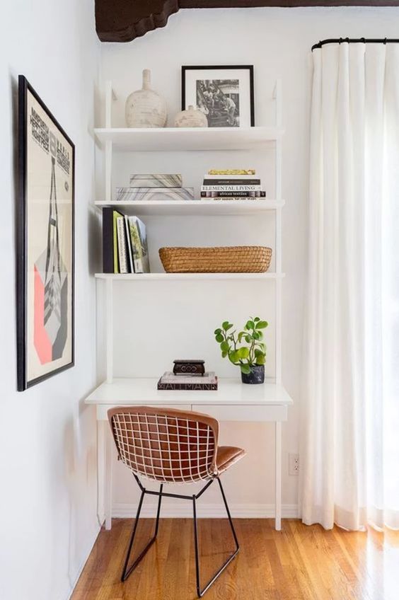 a small nook by the window, with a white shelving unit and desk, a leather chair, potted greenery, books and vases is a very functional idea