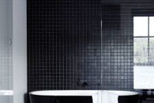 a beautiful contemporary bathroom in black, with small scale tiles, a sleek black bathtub and a black vanity is a lovely idea