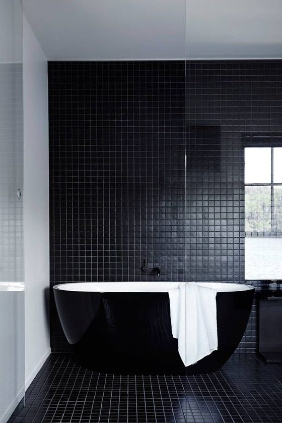 a beautiful contemporary bathroom in black, with small scale tiles, a sleek black bathtub and a black vanity is a lovely idea