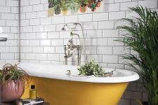 07 a black and white tile floor, white subway tiles on the walls, a mustard clawfoot bathtub and potted plants plus a bold print