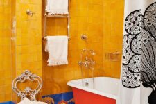 27 a maximalist bathroom with yellow Zellige and colorful tiles, a hot red clawfoot bathtub and printed textiles is wow