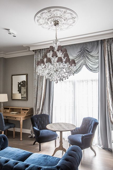 a glam and chic ceiling medallion with an oversized crystal chandelier with taupe lampshades look amazing with each other and add elegance to the room