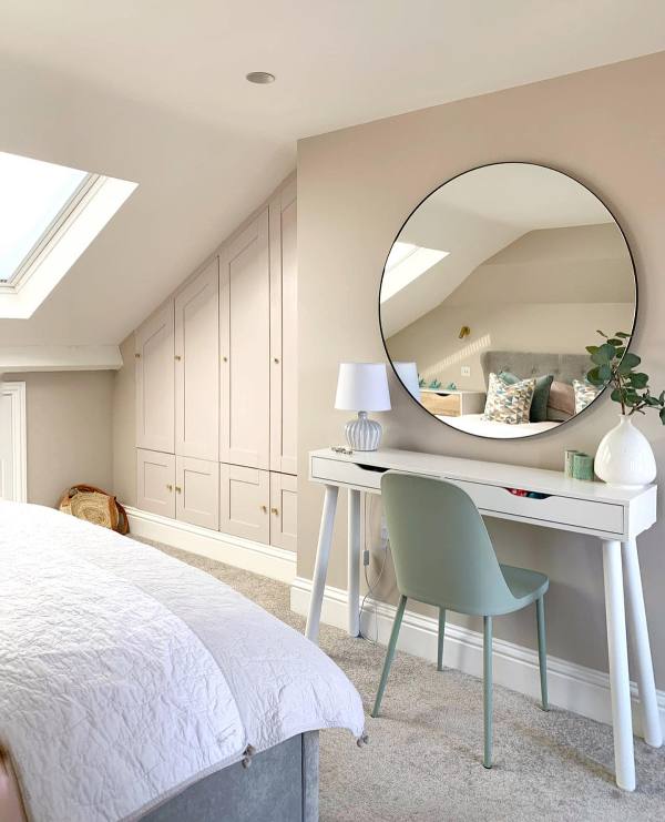 a lovely neutral Scandinavian space with a grey built-in storage unit in the attic corner is a stylish idea to declutter the room
