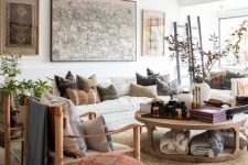 a vivacious living room featuring mid-century modern seating furniture, a bright boho pouf and a round rustic coffee table looks very organic