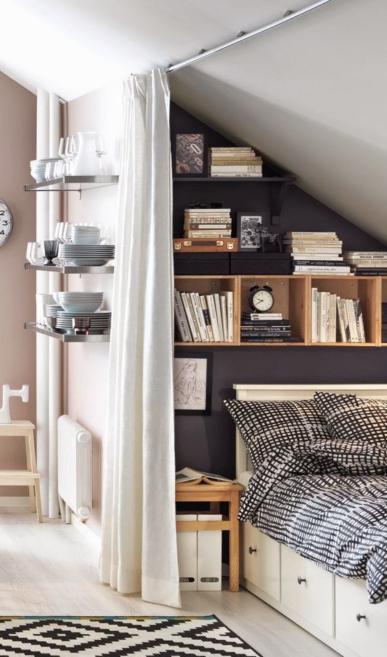 an attic bedroom with smart storage - built-in storage units and shelves for placing books, decor and other stuff