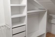an attic closet with built-in storage units, with drawers and open storage compartments is a smart solution to rock