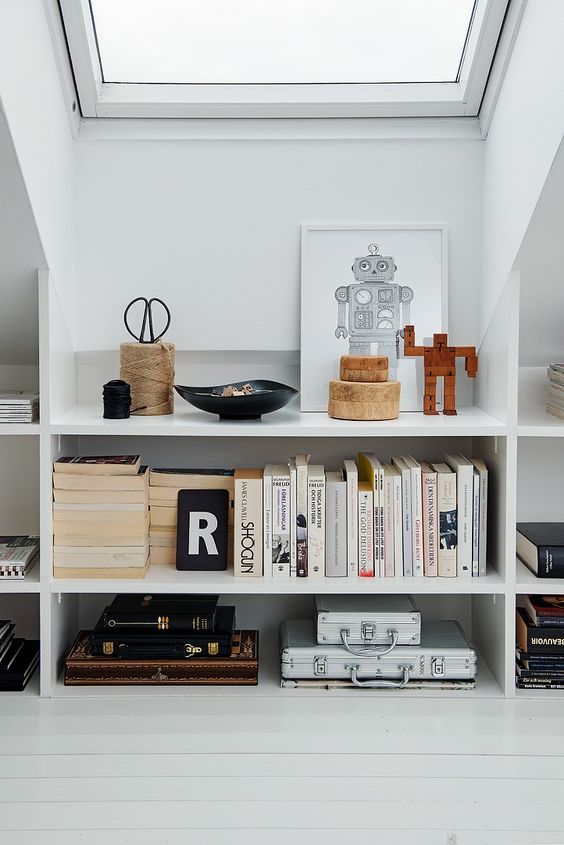 elegant open bookshelves under the roof are a veyr stylish and chic idea for a modern attic - display all the objects you want