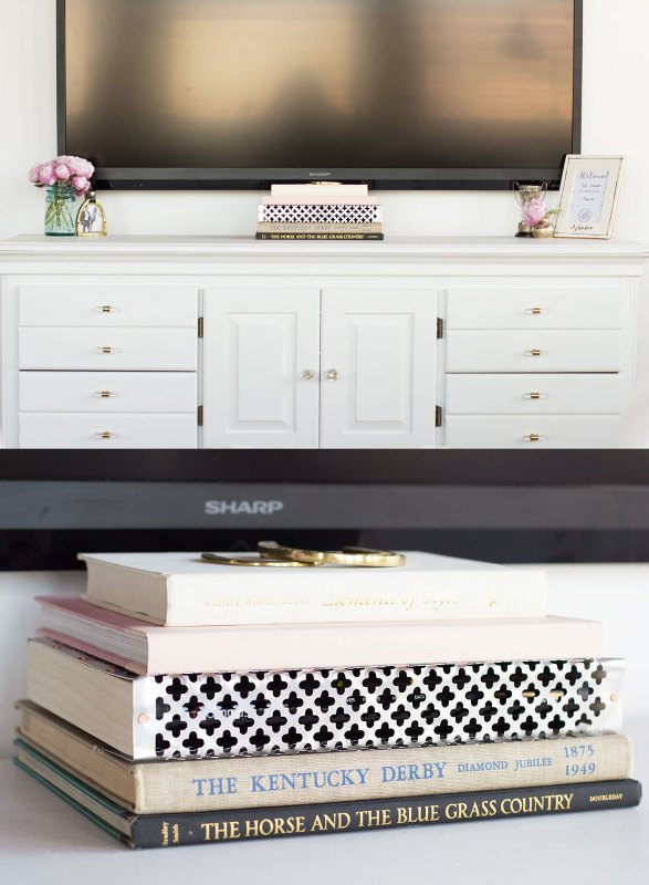 cover your TV cords placing a stack of books strategically and making the space look sleek and elegant