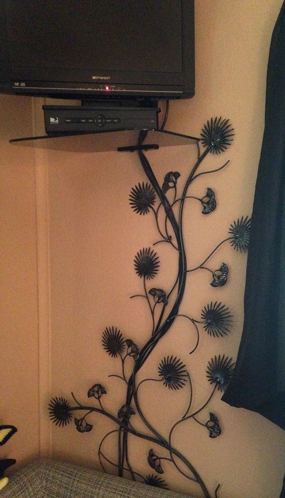find a vine like wall decoration and place it over the cords, it's a smart and cool idea and it will make your space more beautiful