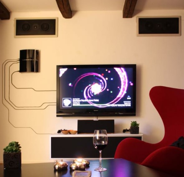 hide your TV wires in plain sight - turn them into a real artwork using clear plastic cable slips, tape and adhesive