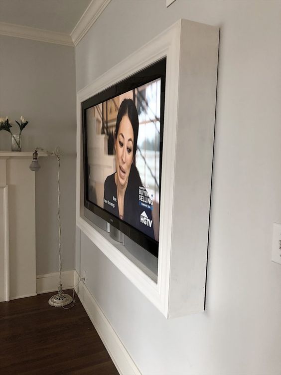 such a white frame around the TV will hide all the wires away and will keep your wall-mounted TV look elegant and very sleek