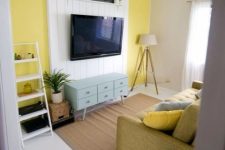 20 a bright living room with a white shipalp accent on the wall used to make the TV stand out and at the same time hide the wires away