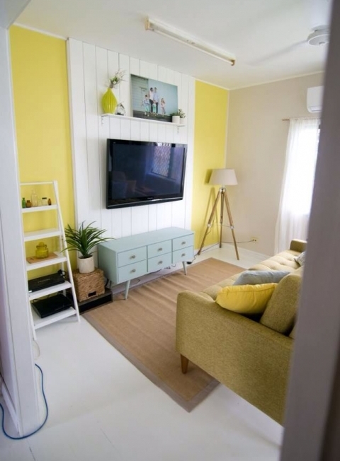 a bright living room with a white shipalp accent on the wall used to make the TV stand out and at the same time hide the wires away