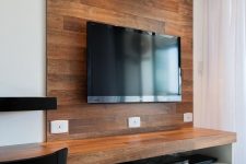 25 a wooden faux wall to highlight the TV and hide all the wires behind it adds a cozy rustic feel to the space and makes it cooler