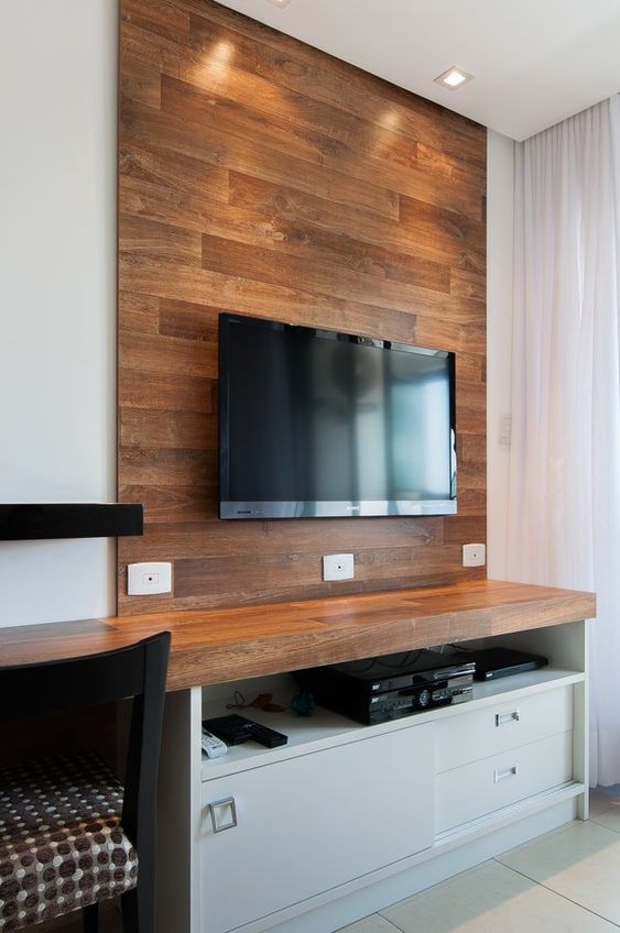 a wooden faux wall to highlight the TV and hide all the wires behind it adds a cozy rustic feel to the space and makes it cooler