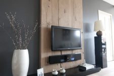 27 build a faux wall of timber that matches your decor, accents the TV and hides all the cords you won’t want to see