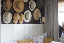 05 a farmhouse space with a whole wall of straw hats and baseball caps that adds eye-catchiness to the space and makes it warm and cool