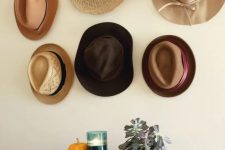 07 a hat gallery wall composed of hooks and pretty hats hanging on them is a lovely idea for a boho or rustic space
