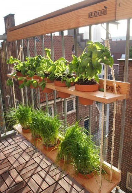 a cool vertical garden on a balcony a vertical garden with a two-tier hanging shelf with planters and lots of greenery is a smart and cool DIY you can go for, it's ideal for any outdoor space