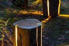 08 tree stumps with lights inside are a very cool and creative idea for a garden or any other outdoor space, and they look dreamy