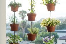 09 hooks with metal hangers and terracotta planters will beautifully dress up your small balcony without taking floor space