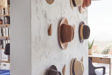 13 a textural wall with wooden hooks from IKEA is a pretty solution to hold your hats, it’s a pretty solution for displaying hats